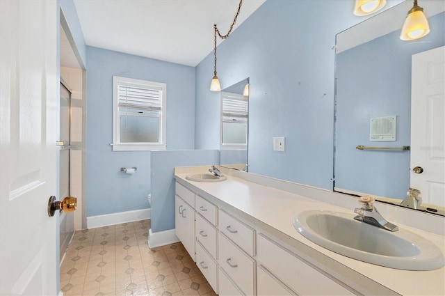 2002 8th St W, Palmetto, FL 34221 - bathroom with double vanity, baseboards, toilet, tile patterned floors, and a shower