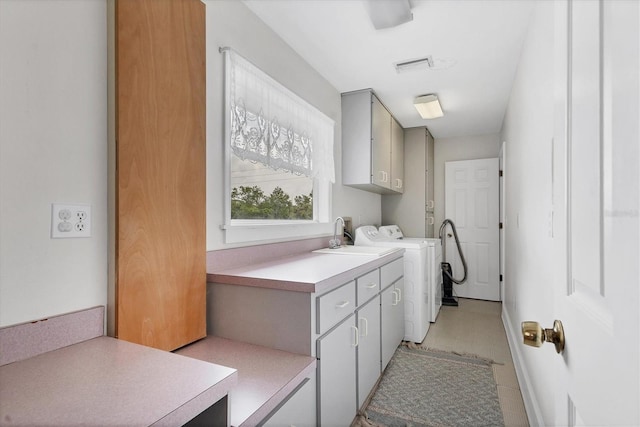 2002 8th St W, Palmetto, FL 34221 - washroom with cabinet space, washer and dryer, and light tile patterned floors