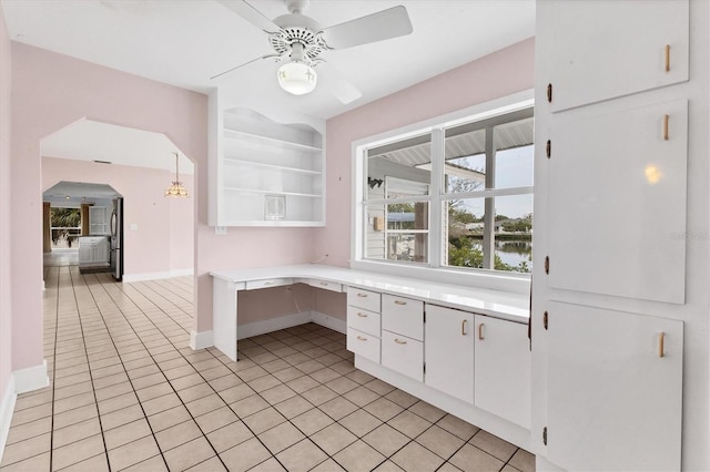 2002 8th St W, Palmetto, FL 34221 - kitchen with light tile patterned flooring, light countertops, a ceiling fan, and baseboards