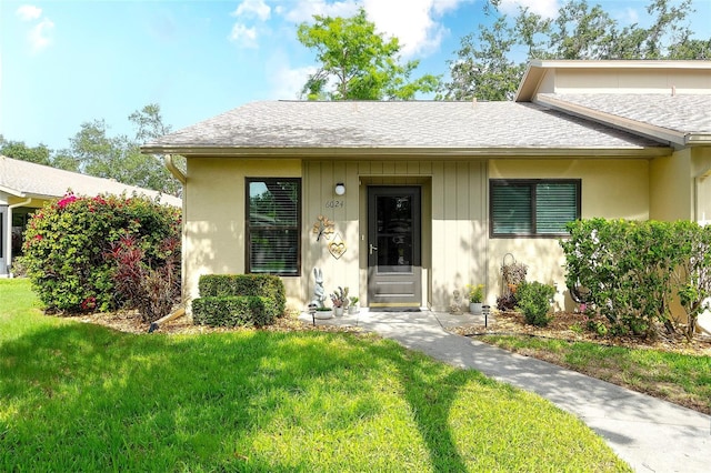 6024 28th St W, Bradenton, FL 34207 - view of front facade with a front lawn and roof with shingles