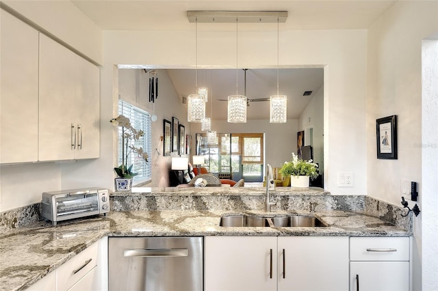 6024 28th St W, Bradenton, FL 34207 - kitchen featuring stainless steel dishwasher, light stone counters, and decorative light fixtures