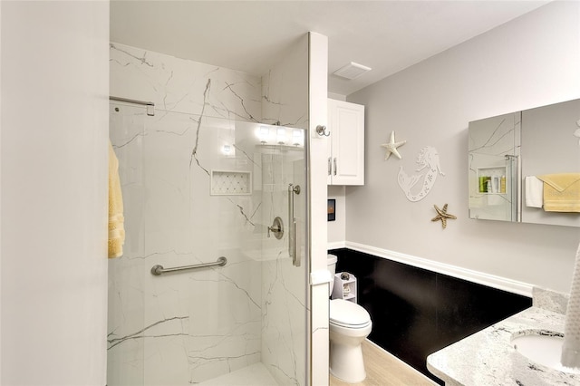 6024 28th St W, Bradenton, FL 34207 - full bathroom featuring vanity, a marble finish shower, and wood finished floors