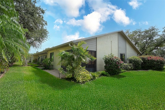 6024 28th St W, Bradenton, FL 34207 - view of home's exterior featuring a lawn and stucco siding
