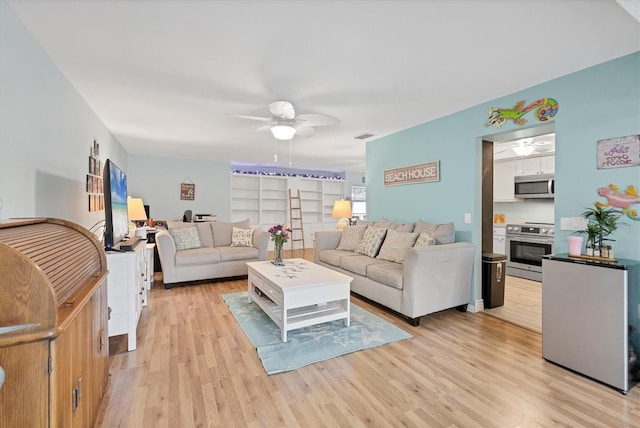 2740 Orchid Oaks Dr Unit 304, Sarasota, FL 34239 - living room with a ceiling fan and light wood finished floors