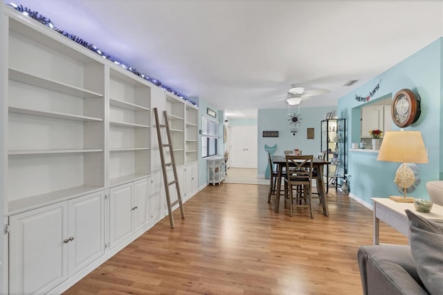2740 Orchid Oaks Dr Unit 304, Sarasota, FL 34239 - dining room with a ceiling fan, light wood-style floors, and baseboards