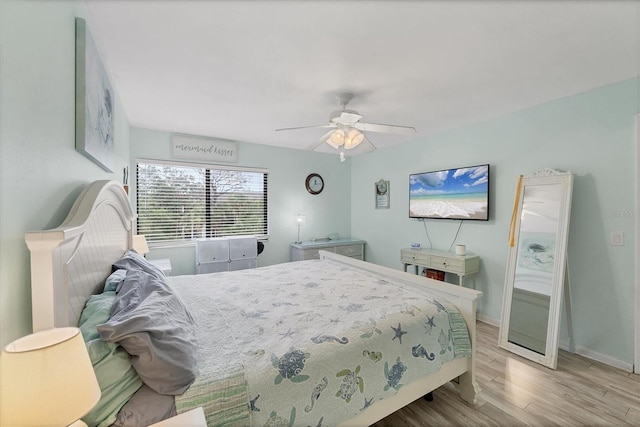 2740 Orchid Oaks Dr Unit 304, Sarasota, FL 34239 - bedroom featuring wood finished floors, a ceiling fan, and baseboards