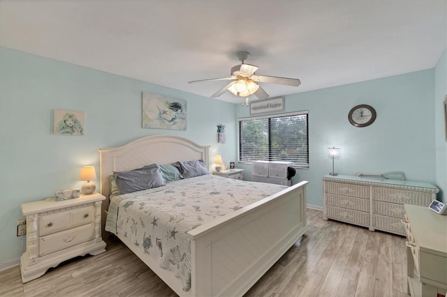 2740 Orchid Oaks Dr Unit 304, Sarasota, FL 34239 - bedroom with light wood-style flooring, baseboards, and a ceiling fan