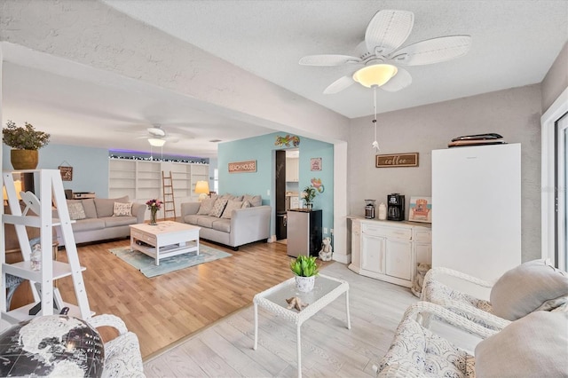 2740 Orchid Oaks Dr Unit 304, Sarasota, FL 34239 - living area with a ceiling fan and light wood-style flooring