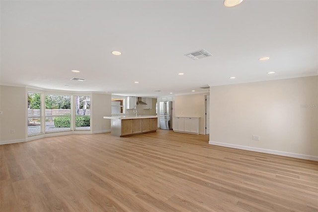 1203 Lyric Ln, Sarasota, FL 34242 - unfurnished living room with crown molding, recessed lighting, and light wood-style flooring