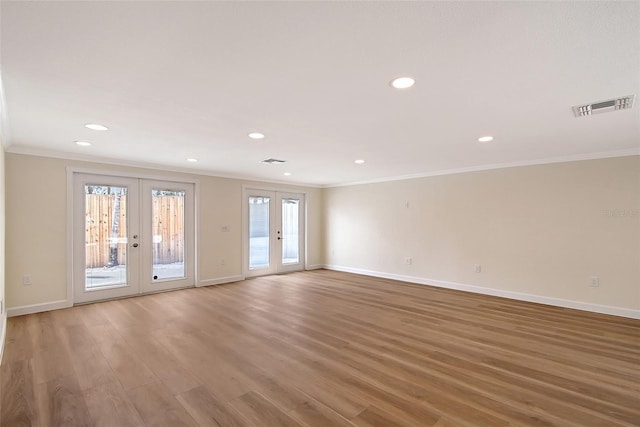 1203 Lyric Ln, Sarasota, FL 34242 - unfurnished room with crown molding, french doors, recessed lighting, and wood finished floors