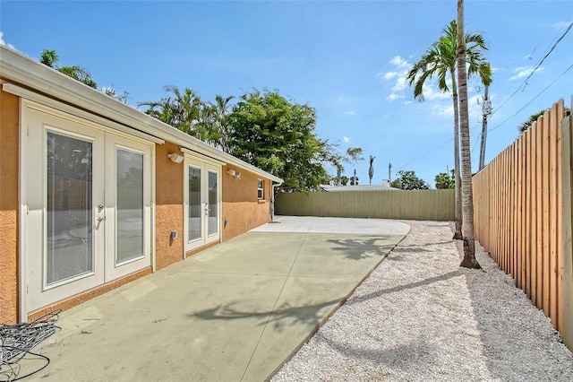 1203 Lyric Ln, Sarasota, FL 34242 - fenced backyard featuring french doors and a patio area