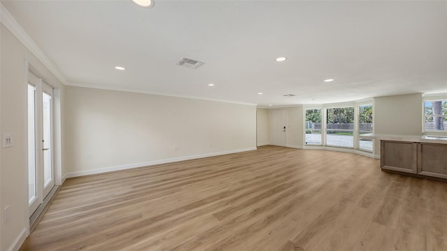 1203 Lyric Ln, Sarasota, FL 34242 - unfurnished living room featuring crown molding, light wood-style floors, and recessed lighting