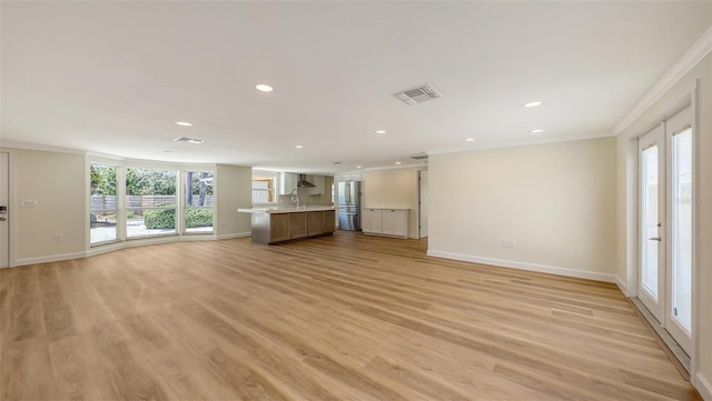 1203 Lyric Ln, Sarasota, FL 34242 - unfurnished living room featuring crown molding, recessed lighting, and light wood-type flooring