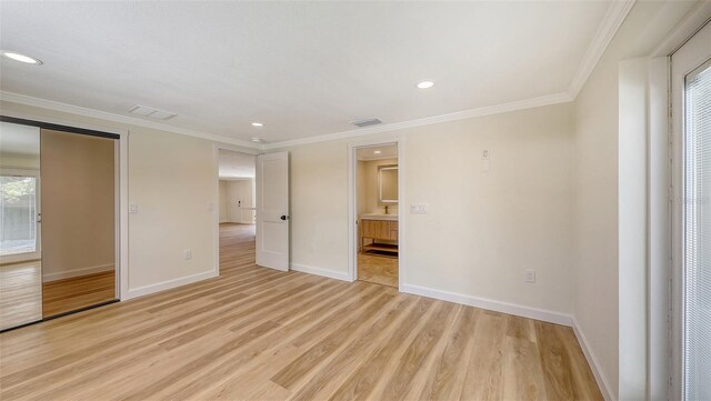 1203 Lyric Ln, Sarasota, FL 34242 - unfurnished bedroom featuring light wood finished floors, recessed lighting, crown molding, and ensuite bathroom