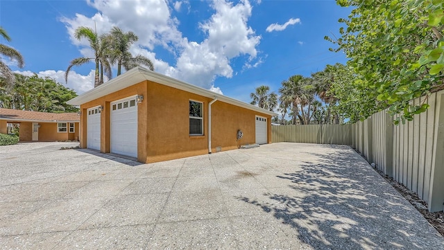 1203 Lyric Ln, Sarasota, FL 34242 - view of side of property with stucco siding and a garage