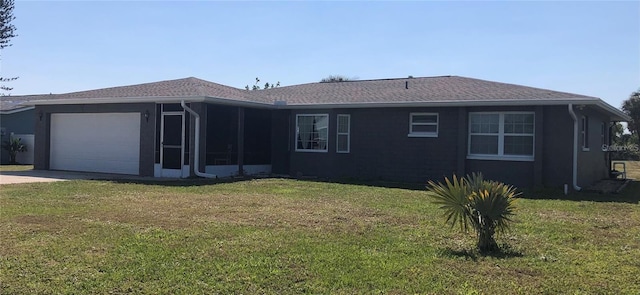 222 Caddy Rd, Rotonda West, FL 33947 - view of front of home with a garage, a front yard, concrete driveway, and roof with shingles
