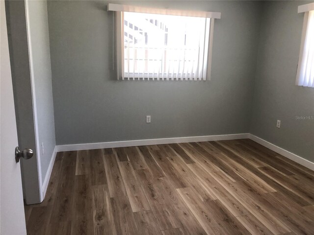 222 Caddy Rd, Rotonda West, FL 33947 - spare room with dark wood finished floors