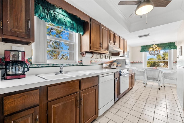 5600 Beach Way Dr Unit 201, Sarasota, FL 34242 - kitchen featuring white appliances, light tile patterned flooring, light countertops, a sink, and a tray ceiling