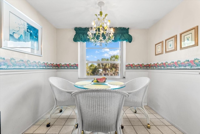 5600 Beach Way Dr Unit 201, Sarasota, FL 34242 - tiled dining space with a chandelier, a wainscoted wall, and baseboards