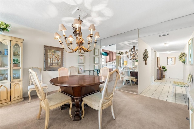 5600 Beach Way Dr Unit 201, Sarasota, FL 34242 - dining room with a chandelier, light colored carpet, and light tile patterned flooring