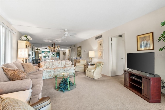 5600 Beach Way Dr Unit 201, Sarasota, FL 34242 - carpeted living room featuring a chandelier and a ceiling fan