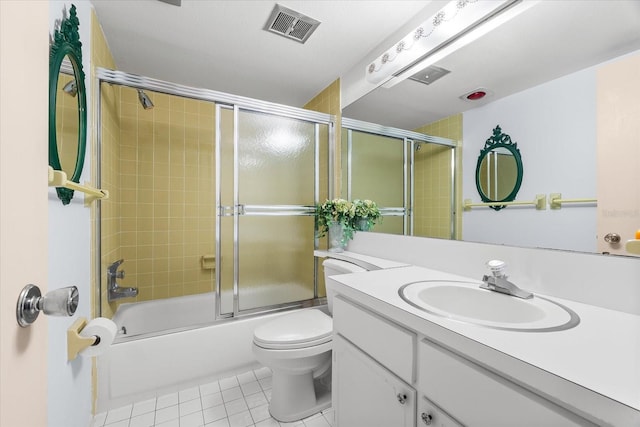 5600 Beach Way Dr Unit 201, Sarasota, FL 34242 - bathroom with tile patterned floors, vanity, toilet, and enclosed tub / shower combo