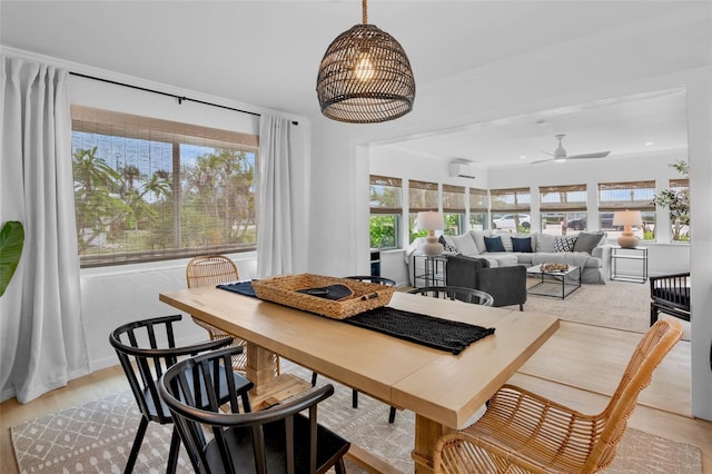 404 Bayshore Rd, Nokomis, FL 34275 - dining space with healthy amount of natural light, a wall mounted AC, and light wood-type flooring