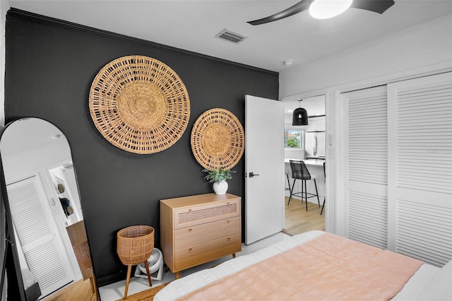 404 Bayshore Rd, Nokomis, FL 34275 - bedroom featuring ornamental molding, stainless steel refrigerator, ceiling fan, wood finished floors, and a closet