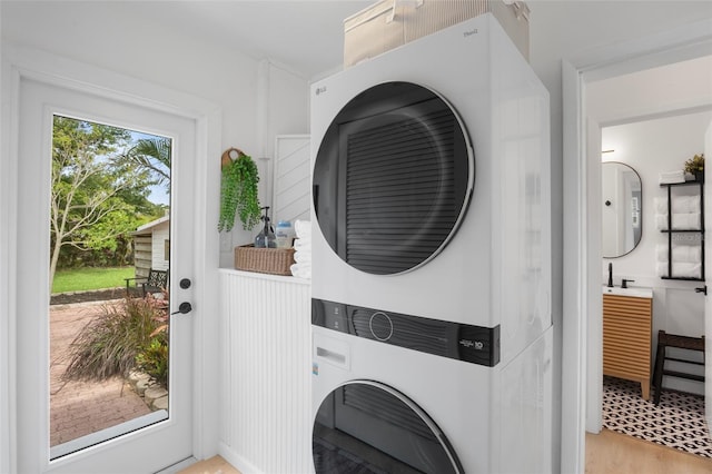 404 Bayshore Rd, Nokomis, FL 34275 - washroom featuring stacked washer / dryer and light wood finished floors