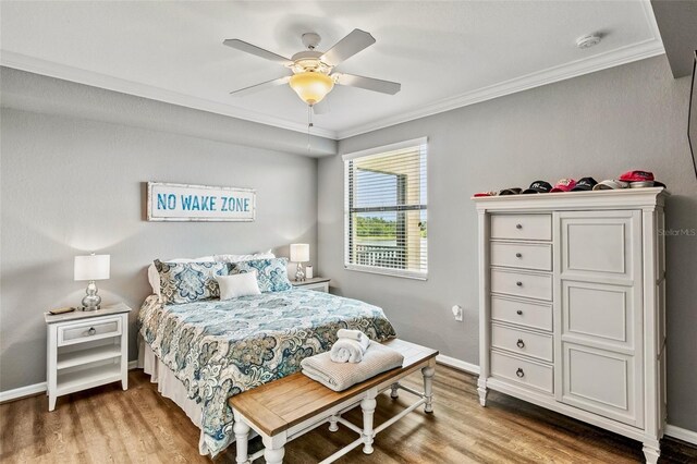 6515 Grand Estuary Trl Unit 208, Bradenton, FL 34212 - bedroom with crown molding, wood finished floors, baseboards, and a ceiling fan