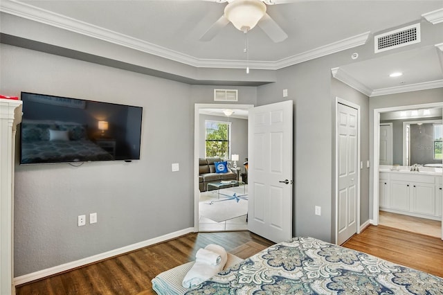 6515 Grand Estuary Trl Unit 208, Bradenton, FL 34212 - bedroom featuring wood finished floors, crown molding, baseboards, a sink, and ensuite bathroom