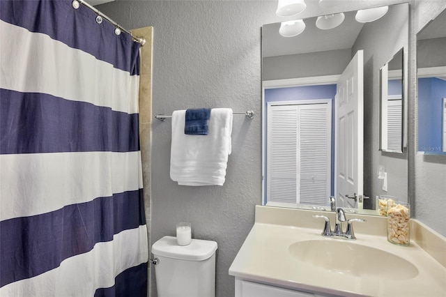 6515 Grand Estuary Trl Unit 208, Bradenton, FL 34212 - bathroom with a textured wall, toilet, vanity, and a shower with curtain