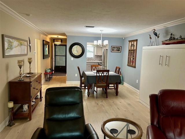 3272 Lake Bayshore Dr Unit 515, Bradenton, FL 34205 - dining space featuring a chandelier, light wood-style flooring, ornamental molding, and baseboards