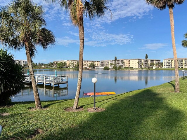 3272 Lake Bayshore Dr Unit 515, Bradenton, FL 34205 - dock featuring a lawn and a water view