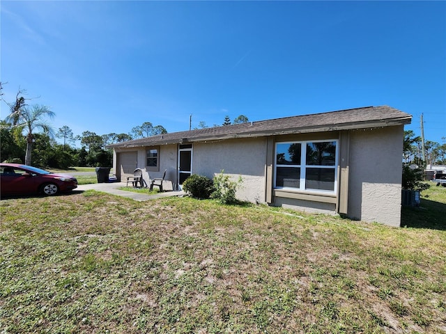 6405 Myrtlewood Rd, North Port, FL 34287 - view of front facade with stucco siding, a garage, and a front yard