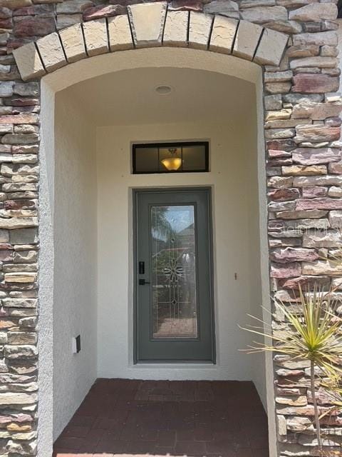 4077 River Bank Way, Punta Gorda, FL 33980 - view of exterior entry featuring stone siding and stucco siding