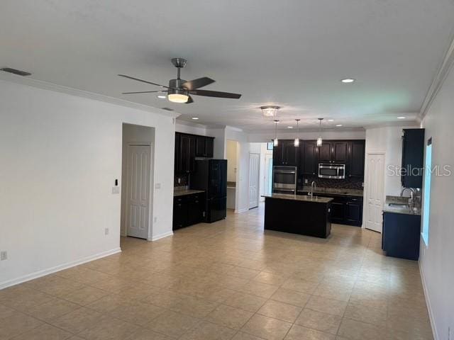 4077 River Bank Way, Punta Gorda, FL 33980 - kitchen featuring stainless steel appliances, a ceiling fan, tasteful backsplash, a kitchen island with sink, and recessed lighting