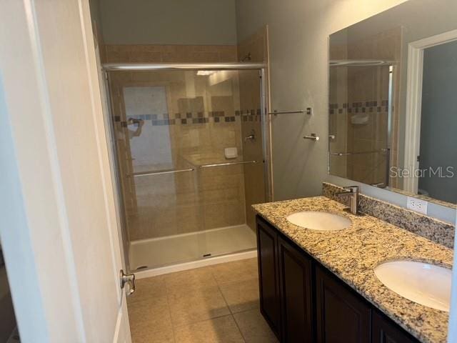 4077 River Bank Way, Punta Gorda, FL 33980 - full bath featuring tile patterned flooring, a stall shower, and double vanity