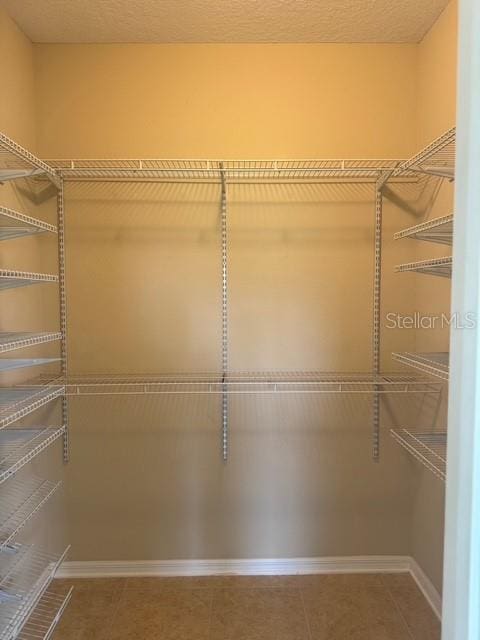 4077 River Bank Way, Punta Gorda, FL 33980 - spacious closet with tile patterned flooring