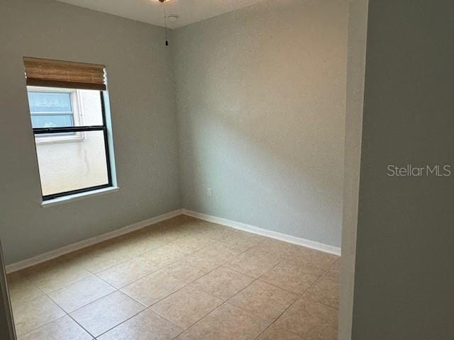 4077 River Bank Way, Punta Gorda, FL 33980 - spare room with light tile patterned floors and baseboards