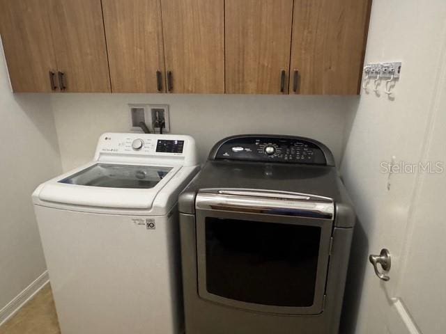 4077 River Bank Way, Punta Gorda, FL 33980 - laundry area with washer and clothes dryer, cabinet space, and baseboards