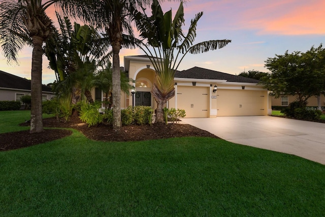 12015 Forest Park Cir, Bradenton, FL 34211 - view of front of property featuring a garage, concrete driveway, stucco siding, and a front yard