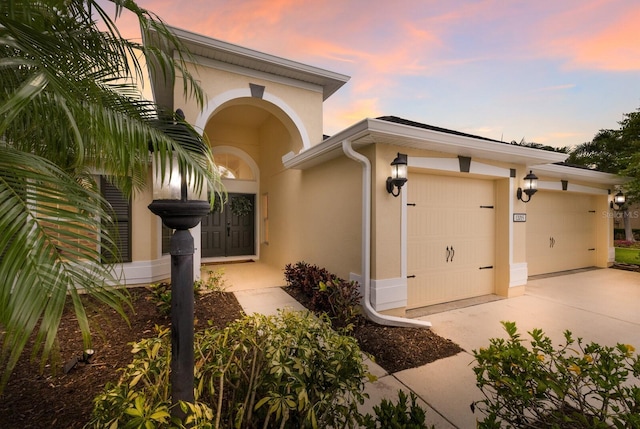 12015 Forest Park Cir, Bradenton, FL 34211 - view of front of house featuring stucco siding, a garage, and driveway