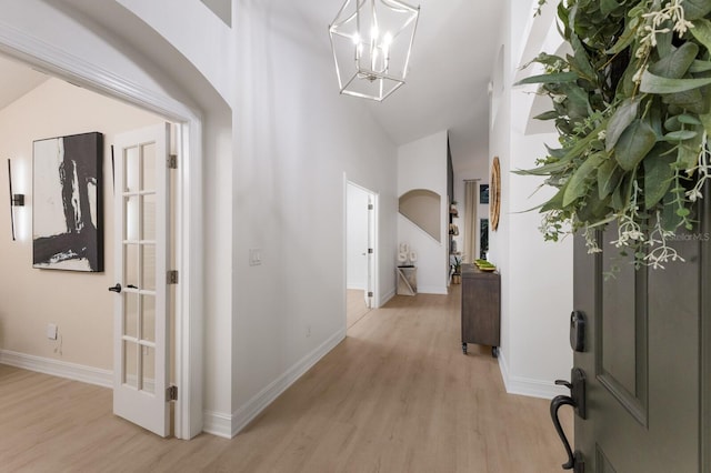 12015 Forest Park Cir, Bradenton, FL 34211 - corridor with light wood-style flooring, baseboards, a chandelier, and high vaulted ceiling