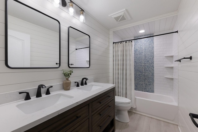 12015 Forest Park Cir, Bradenton, FL 34211 - bathroom with double vanity, toilet, wood finished floors, shower / tub combo, and wood walls