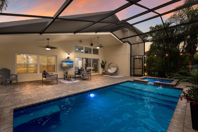 12015 Forest Park Cir, Bradenton, FL 34211 - pool at dusk with a patio area, ceiling fan, a pool with connected hot tub, and a lanai