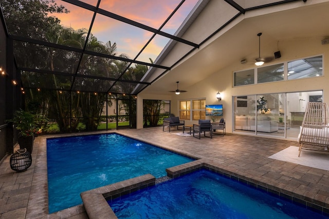12015 Forest Park Cir, Bradenton, FL 34211 - pool at dusk with a patio area, a ceiling fan, a pool with connected hot tub, and a lanai