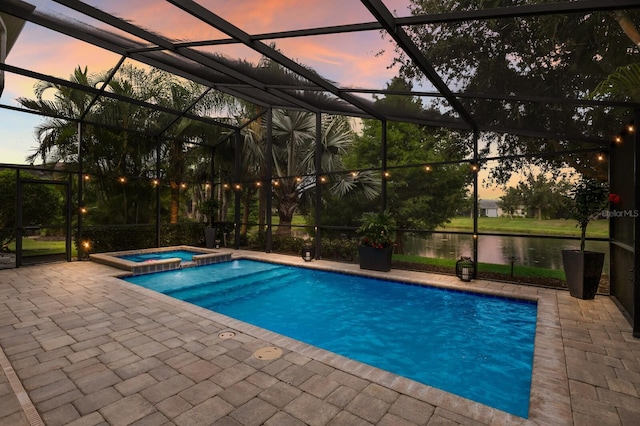 12015 Forest Park Cir, Bradenton, FL 34211 - pool at dusk with a patio, glass enclosure, a pool with connected hot tub, and a water view