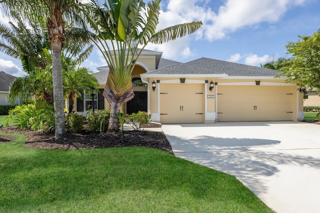 12015 Forest Park Cir, Bradenton, FL 34211 - ranch-style home with a garage, concrete driveway, stucco siding, and a front yard