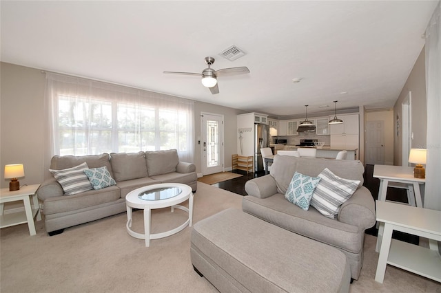 2363 Milford Cir, Sarasota, FL 34239 - living area with a ceiling fan and light colored carpet